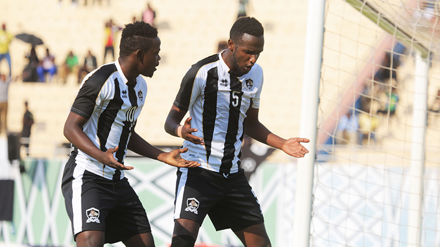 Amran Nshimiyimana (#5) and forward Muhadjiri Hakizimana (#10) celebrate the formeru2019s opening goal during APRu2019s 3-0 win over Police last Thursday at Amahoro Stadium. Sam Ngendahimana.