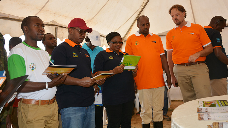 Dr Patrick Ndimubanzi (2nd left); Jeanne du2019Arc De Bonheur, Minister for Disaster Management and Refugee Affairs; Mayor Franu00e7ois Ndayisaba and Mark Bryan Schreiner (right) and other officials inspect family planning services in Karongi District. Courtesy.