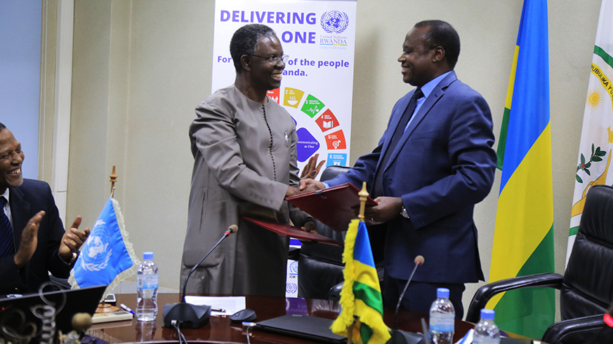 The UN Resident Coordinator in Rwanda, Fodu00e9 Ndiaye (left) and the Minister for Finance and Economic Planning, Uzziel Ndagijimana, exchange documents after signing the agreement in Kigali yesterday. The Government and the One UN Rwanda signed an agreement that will see the latter support development and humanitarian activities in the country over the next five years.  Sam Ngendahimana.
