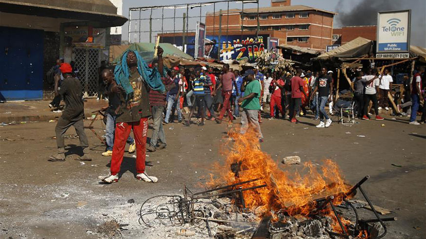 Supporters of the opposition MDC Alliance attend a protest in Harare, Zimbabwe, Aug. 1, 2018. Three people died and scores of others were injured Wednesday when protesting opposition supporters clashed with army and police in the capital Harare. Scores of opposition supporters took to the streets of Harare to protest against the delay in announcement of presidential election results as well as alleged rigging of the vote. (Xinhua/Shaun Jusa)