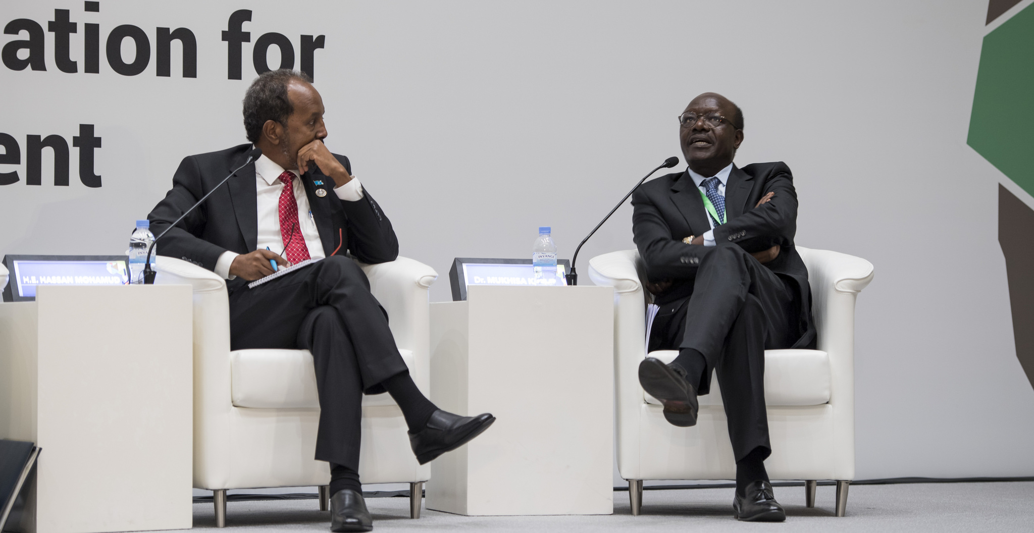 Dr Mukhisa Kituyi, the Secretary-General of the United Nations Conference on Trade and Development, makes a point as former Somali president Hassan Sheikh Mohamud looks on during a panel discussion at Kigali Convention Centre yesterday. Village Urugwiro.
