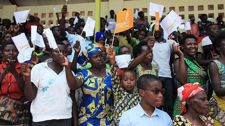 Nyanza residents cheer on celebrated female Inanga performer, Sophie Nzayisenga (centre - right) and her band, as they entertain guests at the event.