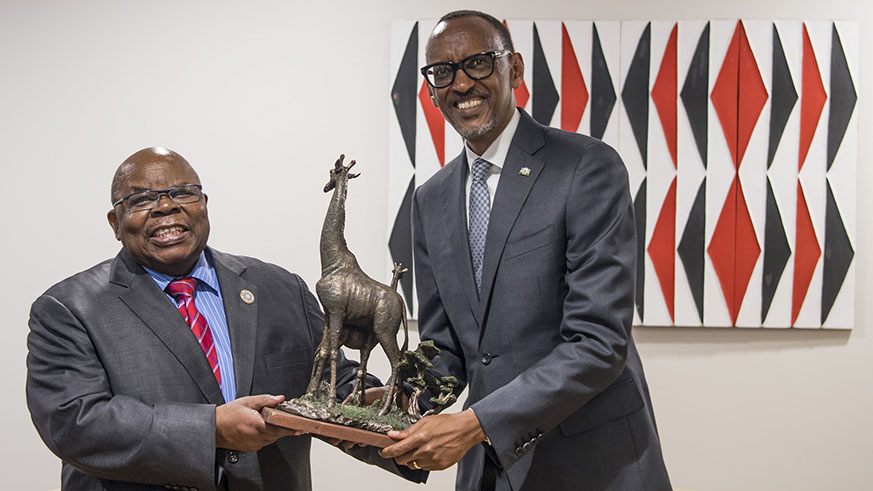 President Kagame receives a gift from the host of the summit and former Tanzanian leader, Benjamin William Mkapa, in Kigali yesterday. Kagame, who is the current African Union Chairperson, is leading an AU reform effort designed to make the continental organisation more effective. Village Urugwiro.