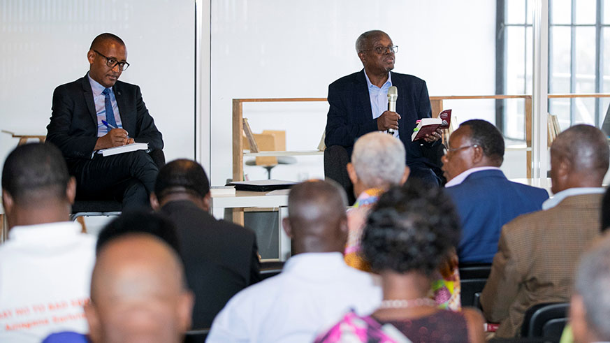 Former Senator Mugesera (R) and Diogene Bideri, the Principle Legal Advisor at National Commission for the Fight against Genocide (CNLG), and other participants during the launch of his new book. Courtesy.