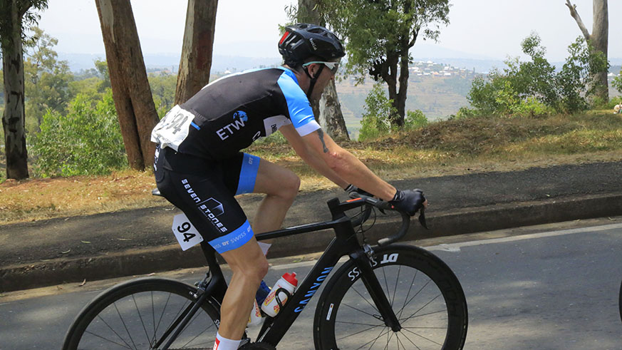 Embrace the World cycling team rider Rugg Timothy climbs Nkoto hill in Kamonyi