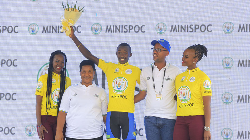 Governor of South Province and Ferwacy boss Aimable Bayingana gives Team Rwanda Captain Samuel Mugisha yellow jersey as he wins Stage 2 of Tour du Rwanda from Kigali to Huye (Sam Ngendahimana)