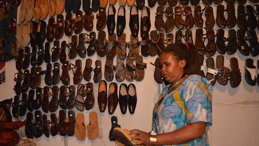 Xavera Mamamukali, the 52-year old woman  makes looking at her shoes in Exhibition.Michel Nkurunziza