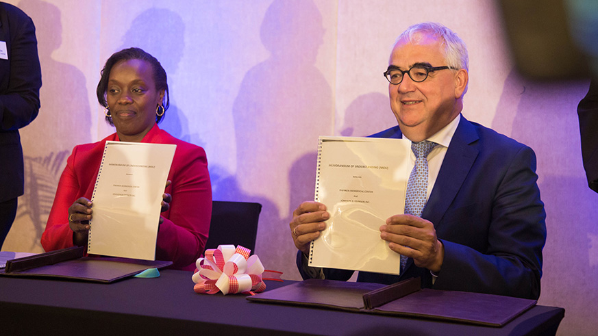 Minister Gashumba (L) and Paul Stoffels sign a partnership agreement on Transforming Mental Health Care in Rwanda. Nadege Imbabazi. 