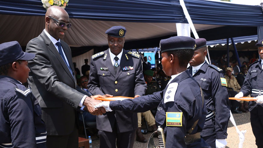 Busingye congratulates one of the Officer Cadets  upon conferring her the rank of Assistant Inspector of Police yesterday. Courtesy. 