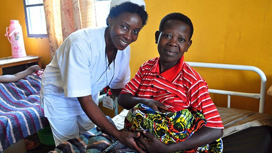 A nurse helps a mother breastfeed  her newborn baby. /File photo