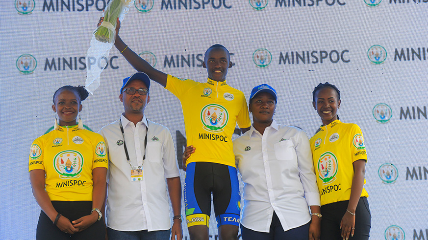 Minister for Sports and Culture, Julienne Uwacu, and FERWACY president Aimable Bayingana, pose with Team Rwanda captain Samuel Mugisha as he retains yellow jersey in the ongoing Tour du Rwanda which ends with a circuit around Kigali today. The race will be concluded from Kigali Stadium in Nyamirambo. 