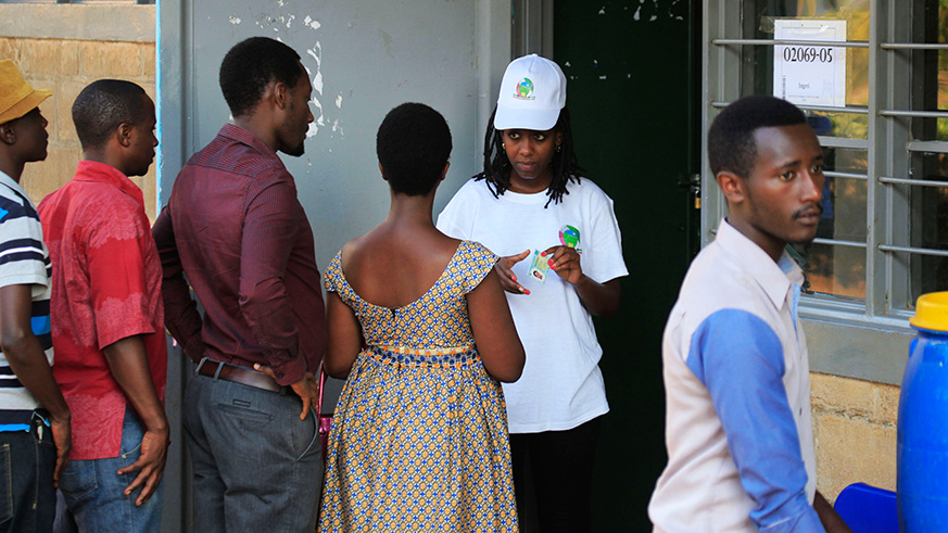 NEC volunteer helps voters during the presidential elections at G S Kimironko II in Kigali last year. Sam Ngendahimana.