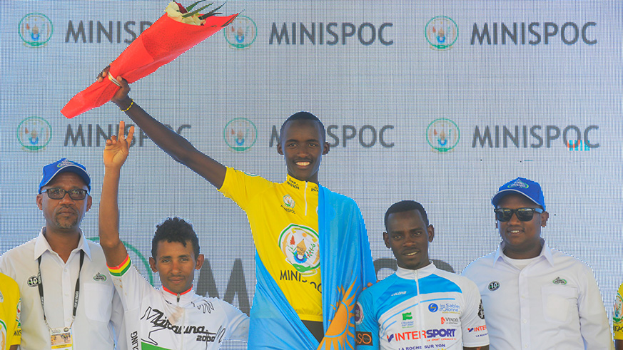 Newly crowned Tour du Rwanda champion Samuel Mugisha (centre), first runner-up Jean Claude Uwizeye (2nd right) and second runner-up Ethiopian Mulu Hailemichael (2nd left), flanked by officials, celebrate their achievement in Kigali yesterday, after topping the general classification of the 2018 Tour du Rwanda. Sam Ngendahimana.
