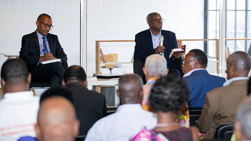 Former Senator Mugesera (R) and Diogene Bideri, the Principle Legal Advisor at National Commission for the Fight against Genocide (CNLG), and other participants during the launch of his new book. 