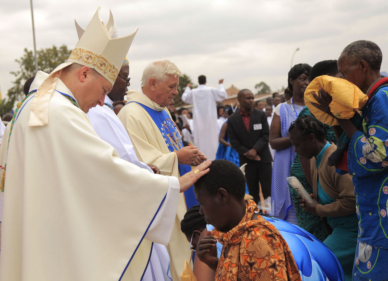 Clerics bless pilgrims after giving their offerings during a Mass to celebrate the Assumption Day at Kibeho last year. Sam Ngendahimana.