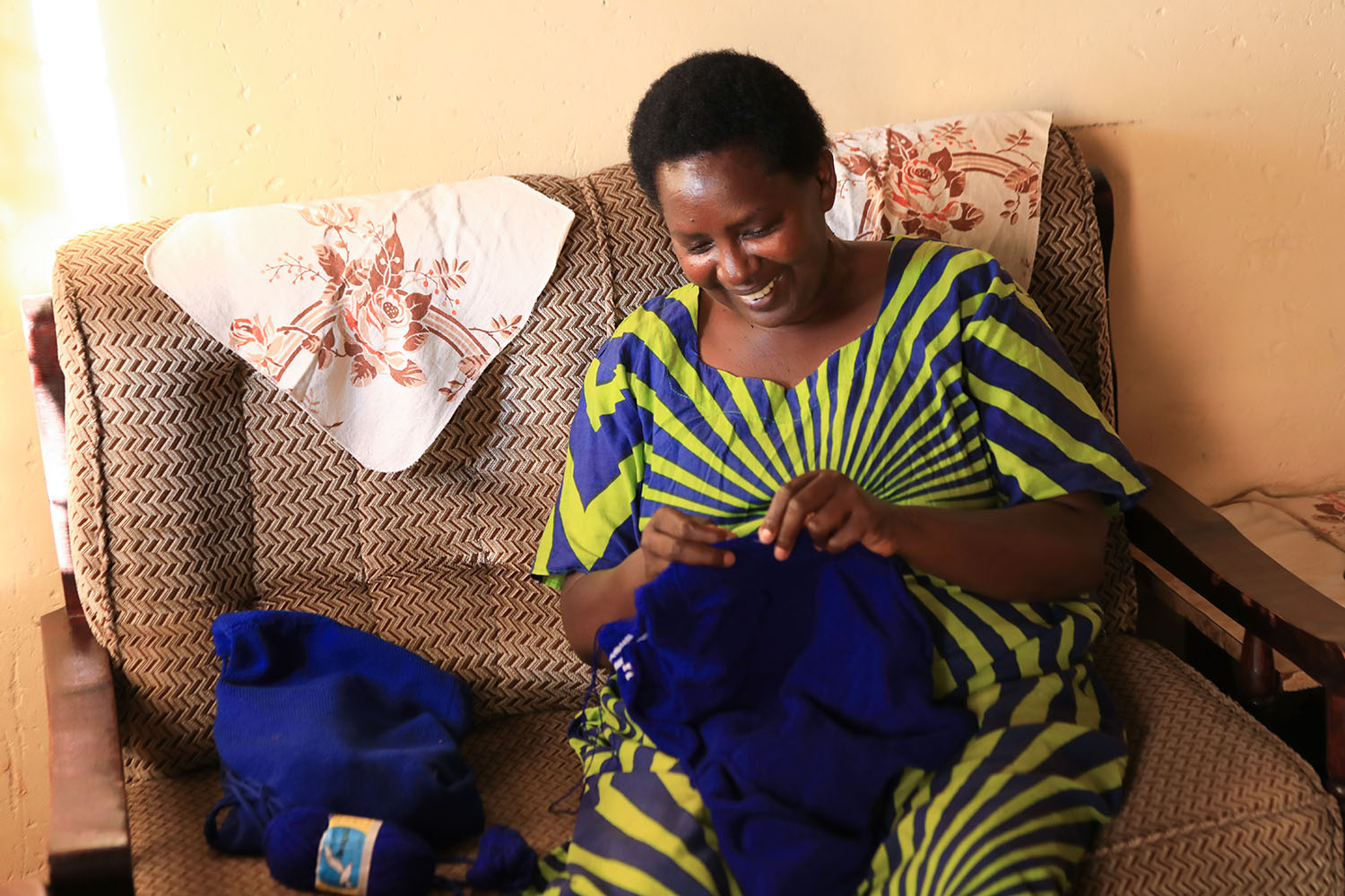 Patricia Nsabyimana relies on her sense of touch to make school sweaters. /Photos by Emmanuel Kwizera