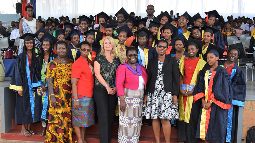 Dr Christine Gasingirwa, the Director of Science and Technology at the Ministry of Education (2nd left, front row), FAWE and MasterCard officials pose with the scholars. Marie Anne Dushimimana.