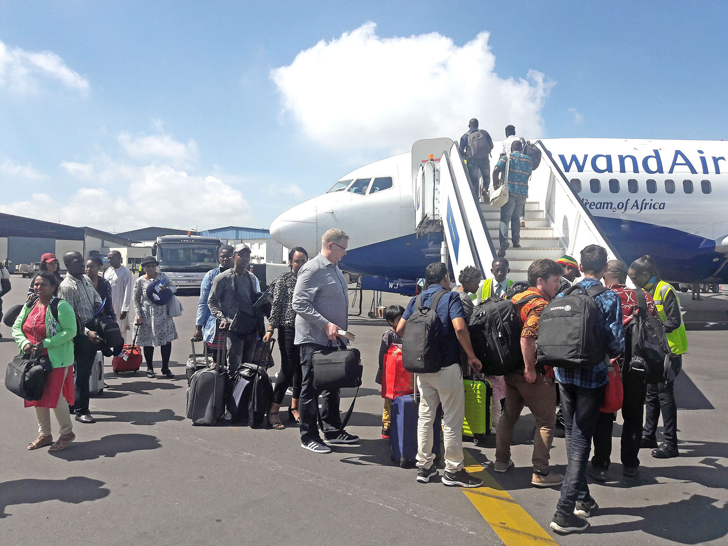 Passengers envroute to Abuja board a Rwandair plane at the Kigali International Airport. Courtesy