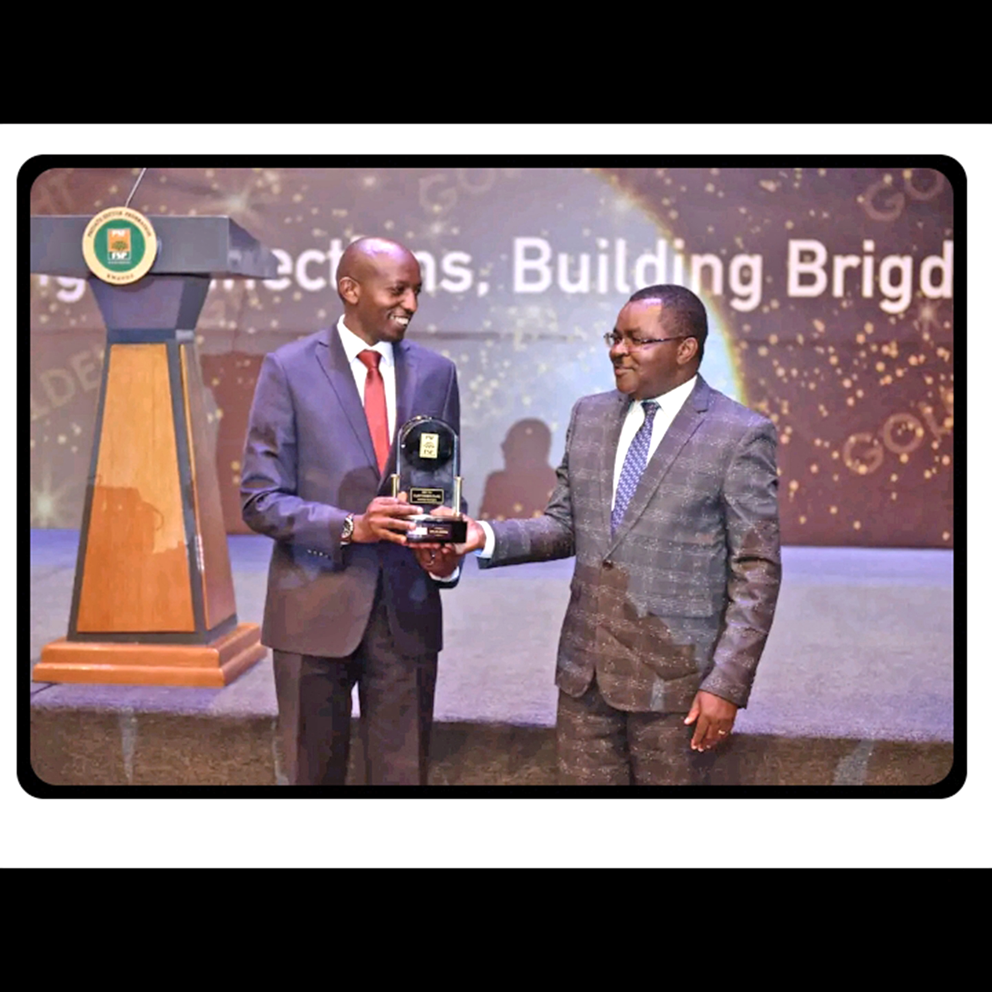 Afrique Ramba, BPRâ€™s COO receives the award from Vincent Munyeshyaka, minister of trade and industry yesterday.