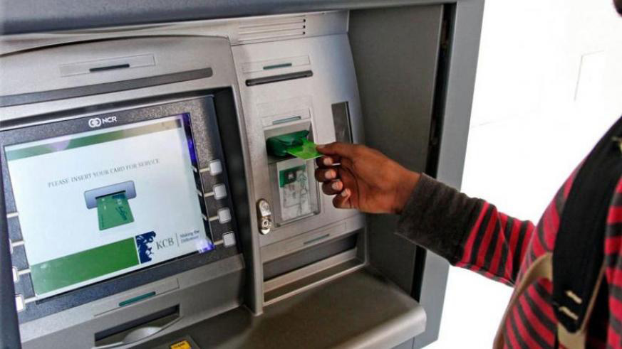 A bank customer makes a transaction at an automated teller machine in Kigali. East Africau2019s banking customers could soon gain access to cheaper ATM withdrawal in an integrated regional banking switch. Net photo.