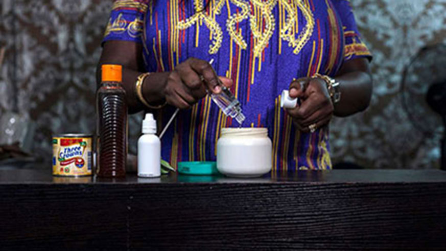 A beauty salon owner, mixes a skin lightening cream in Lagos, Nigeria. Net photos.