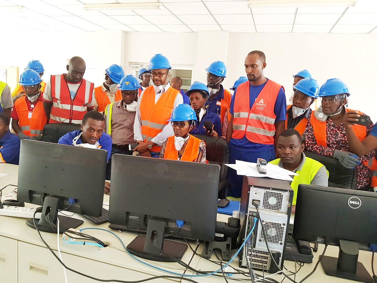 Eng. Coletha Ruhamya, Director General of Rwanda Environment Management Authority, and other officials look at computers which have special software designed to burn contaminated oils. Frederic Byumvuhore.