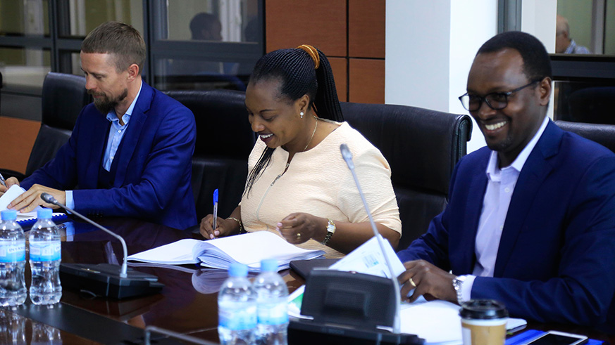 L-R: Sawmill East Africau2019s Chief Executive Agnis Magelinskas, Minister for Land and Forestry, Francine Tumushime, and RDB Chief Operating Officer Emmanuel Hategeka sign the MoU in Kigali yesterday. Sam Ngendahimana.