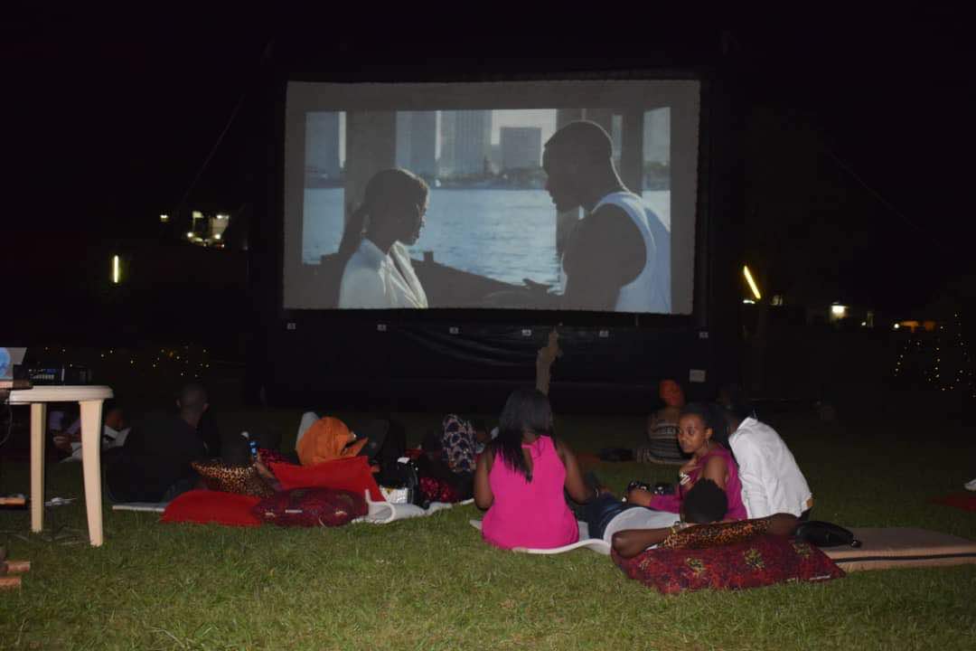 People watch a movie outdoor.