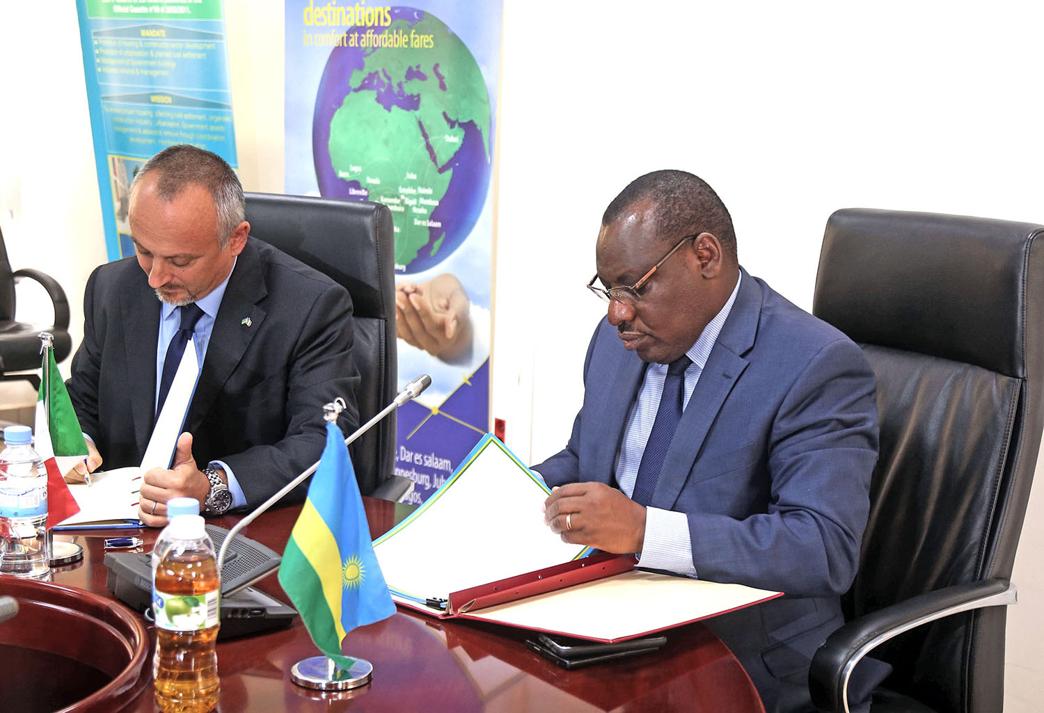 Amb. Domenico Fornara (L) and Minister for Infrastructure Claver Gatete sign the MoU in Kigali yesterday. Sam Ngendahimana.