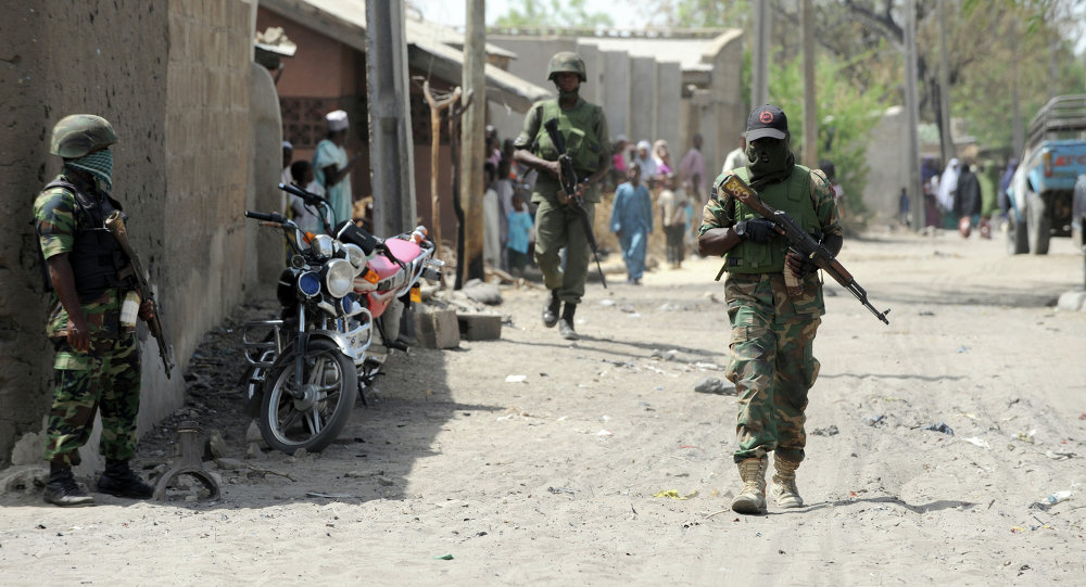 Soldiers walk in the street in the remote northeast town of Baga, Borno State. / Sputnik