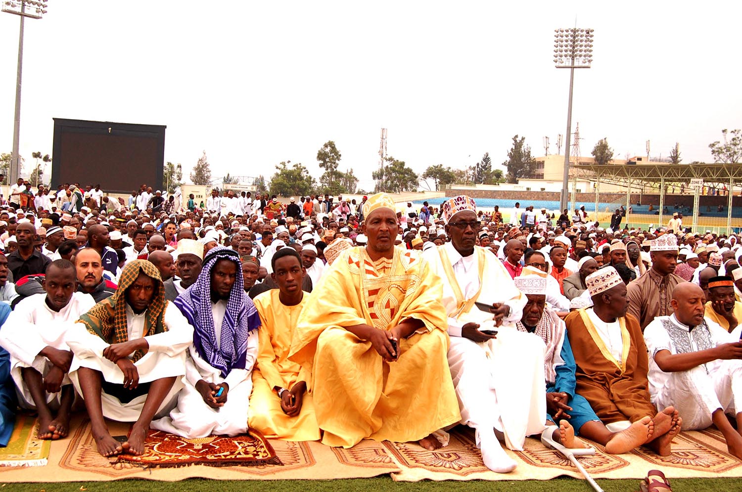 Muslim faithfuls follow a speech by the Mufti of Rwanda, Sheikh Salim Hitimana, at Kigali Stadium yesterday. Photos by Frederic Byumvuhore