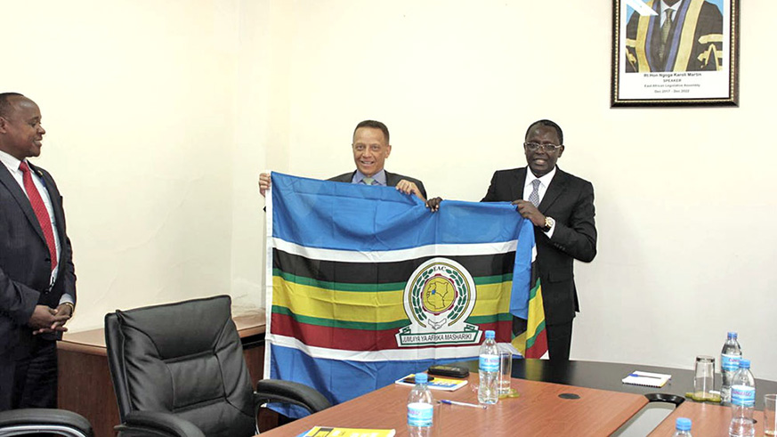 EALA Speaker Martin Ngoga (R) presents the EAC flag to  EABC Chairman Nicholas Nesbitt. File photo.