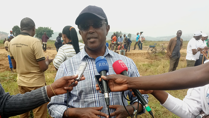 Minister for Environment, Dr. Vincent Biruta, speaks to journalists during the u2018specialu2019 Umuganda to restore wetlands in Nduba Sector yesterday. Emmanuel Ntirenganya.