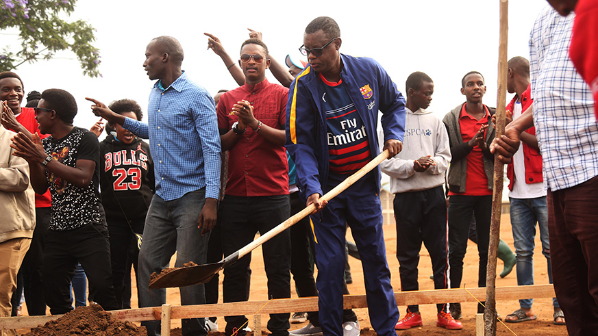 Minister for Defense, James Kabarebe, lays a foundation for the construction of 18 new classrooms at Groupe Scolaire Kimironko I during Umuganda community service yesterday. Sam Ngendahimana.