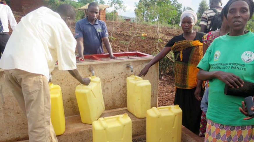 City dwellers draw water from a public source. File.