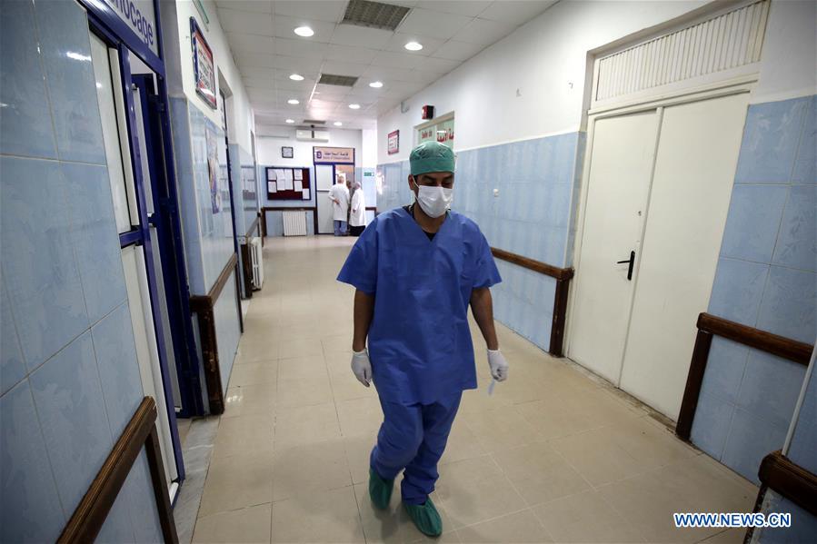 A medical worker walks in the Boufarik Hospital, where many suspected cases of cholera are being treated, in Blida Province. / Xinhua