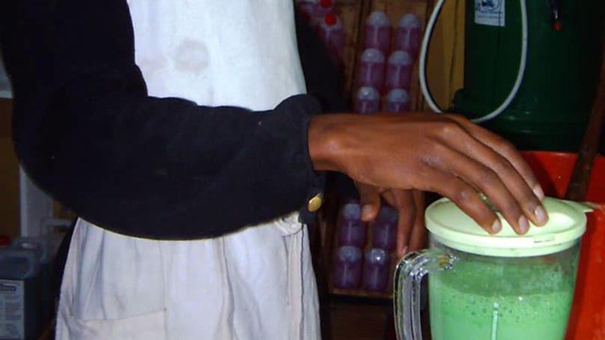 Nshimiyimana blending avocado, to make soap.