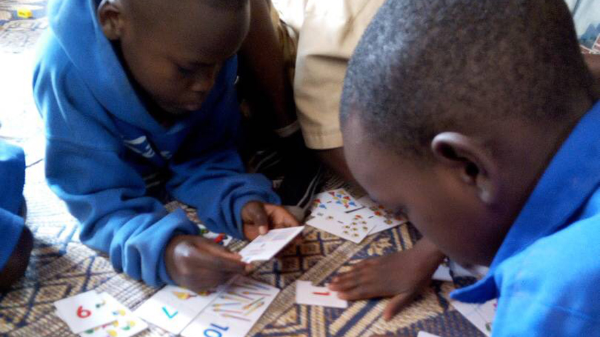 Children with word games at the centre. 