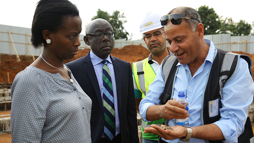 Engineer Khaled M ALAlem gives details to Kigali City Mayor Marie Chantal Rwakazina and Dennis Karera  during tour at the project for relocation of Kangondo village residents. The project is in Busanza ,Kicukiro.