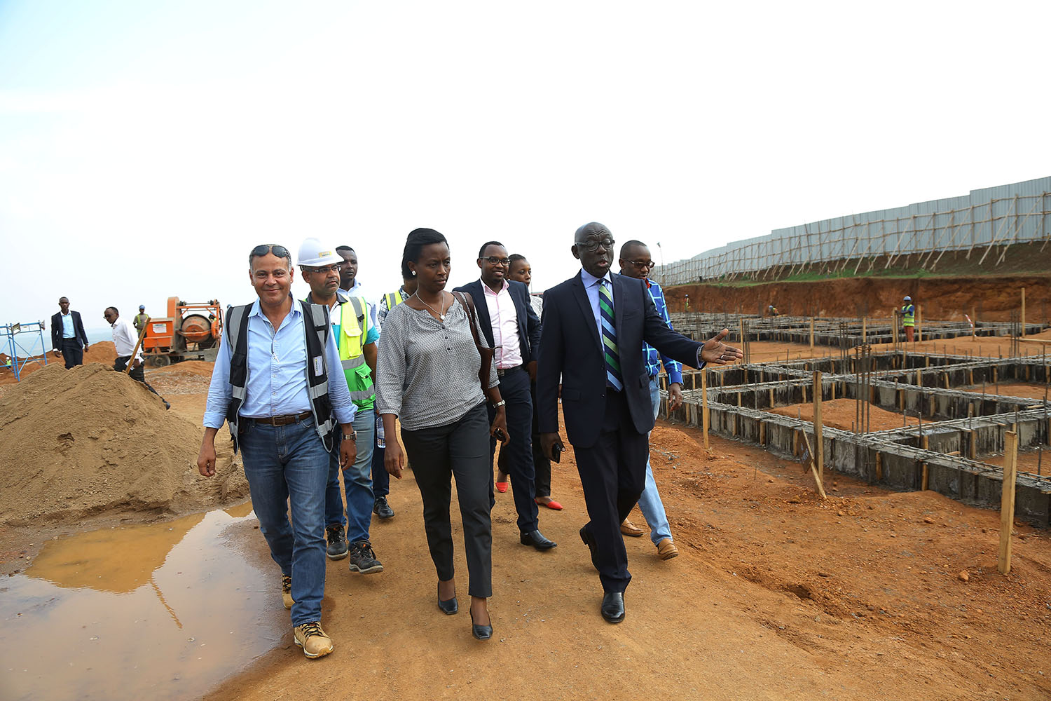 City of Kigali Mayor, Marie Chantal Rwakazina, flanked by city businessman Denis Karera (right), on a guided tour of a site in Busanza, Kicukiro District where over 1000 housing units are being developed. The houses will be taken up by residents who are  set to relocate from an unplanned neighbourhood in the Nyarutarama area, Gasabo District. Ngendahimana.