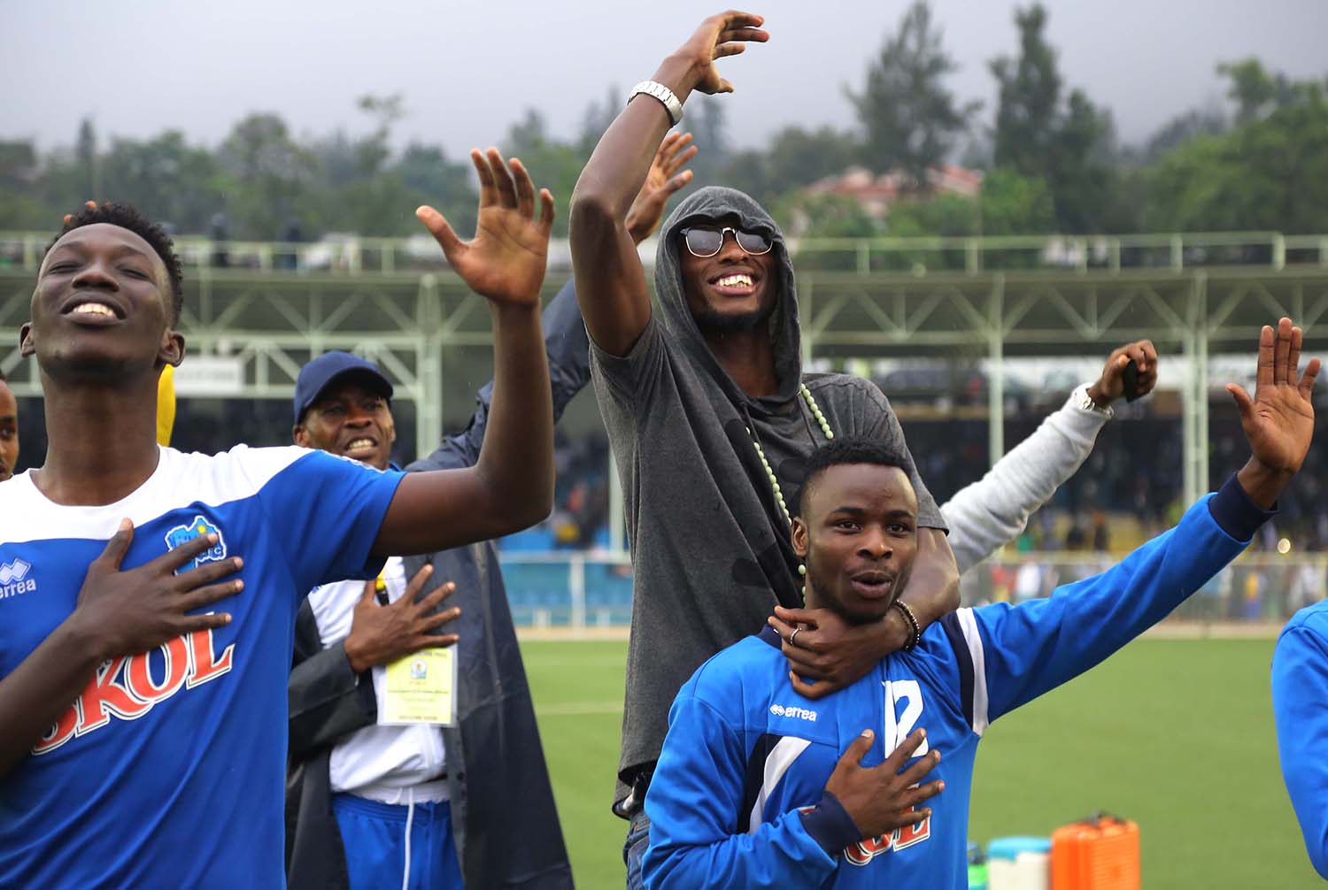 Rayon Sports defender Thierry Manzi joins his teammates to celebrate the victory