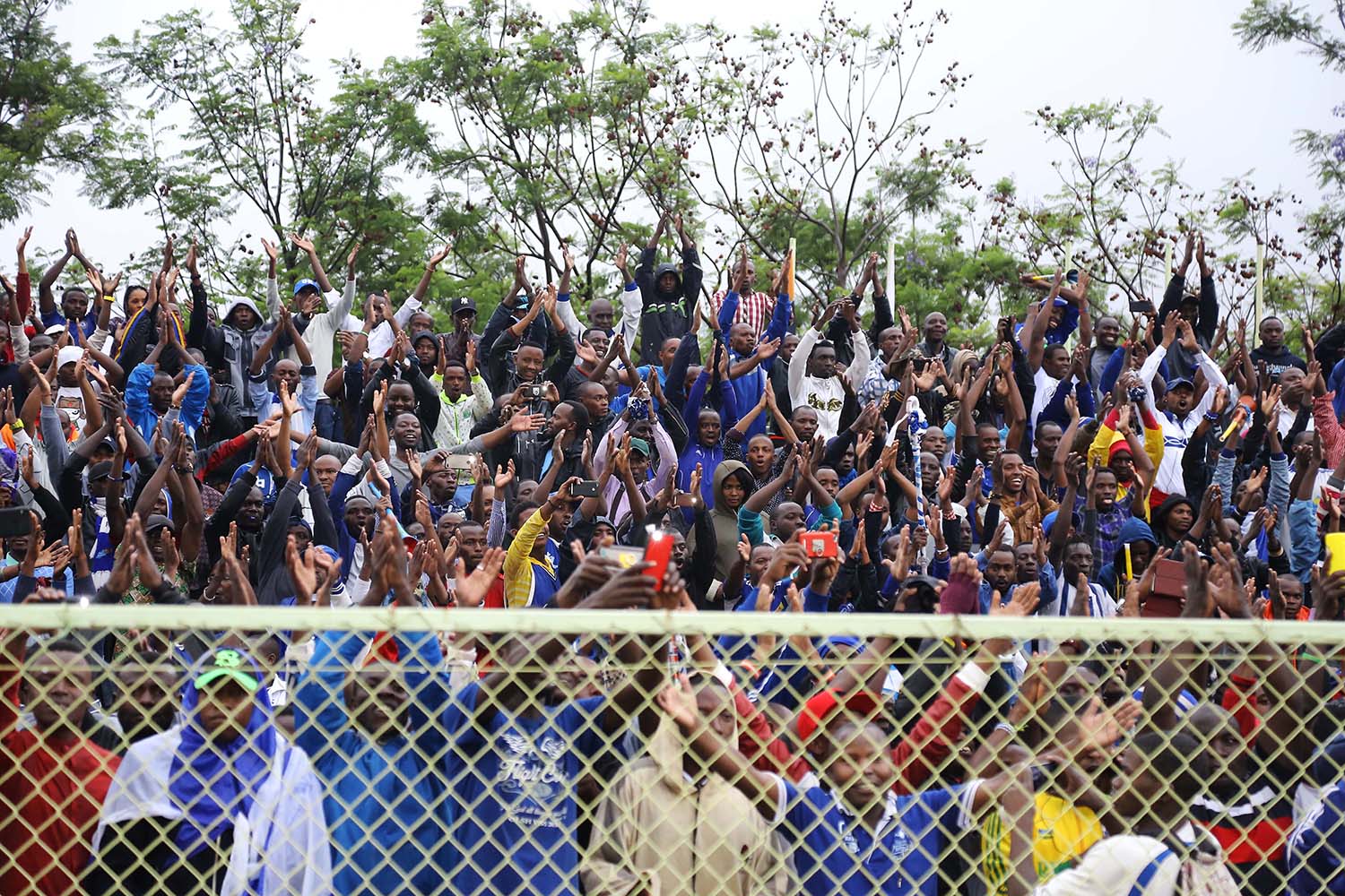 Supporters cheer on their players after qualifying their side
