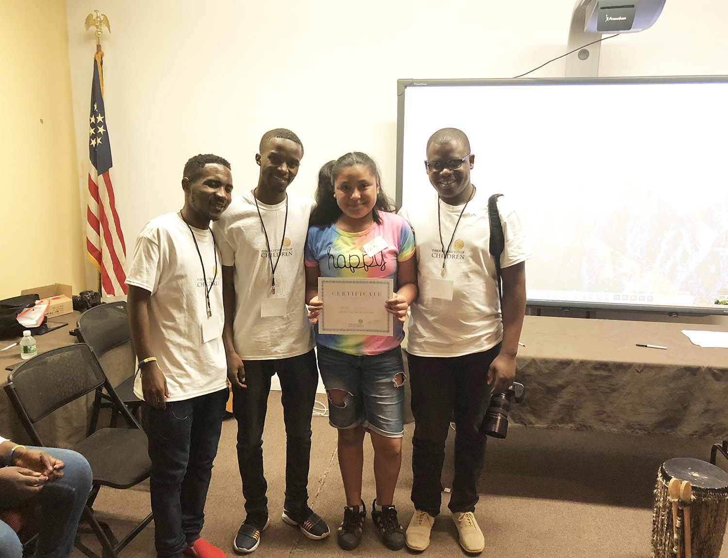 One of the children in the US who received a certficate after her training poses with Habumugisha (second left) and other mentors. Courtesy photos 