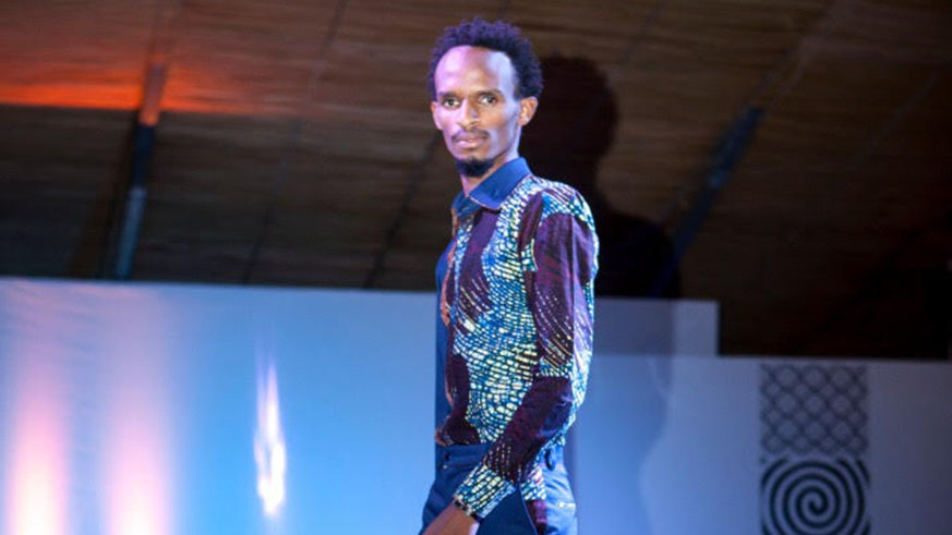 A model walks the runway in menâ€™s casual African print.