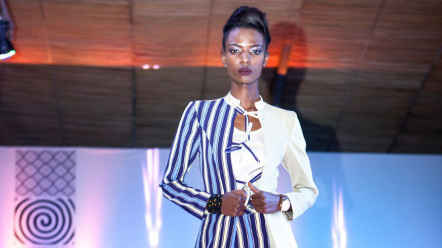 A model showcases designs on the runway at the show. Photo by Charles Ndushabandi.