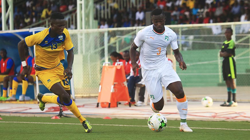 France based player Ghislain Nclomande dribbles  past Rwandan left back Fitina Ombolenga
