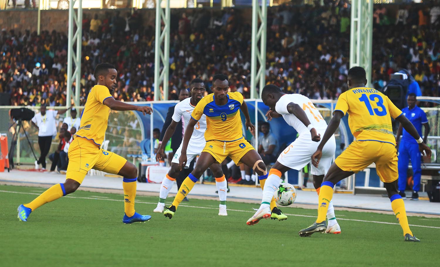 Ivory Coast forward Max Alain Gradel tries to go past Rwandan midfielders