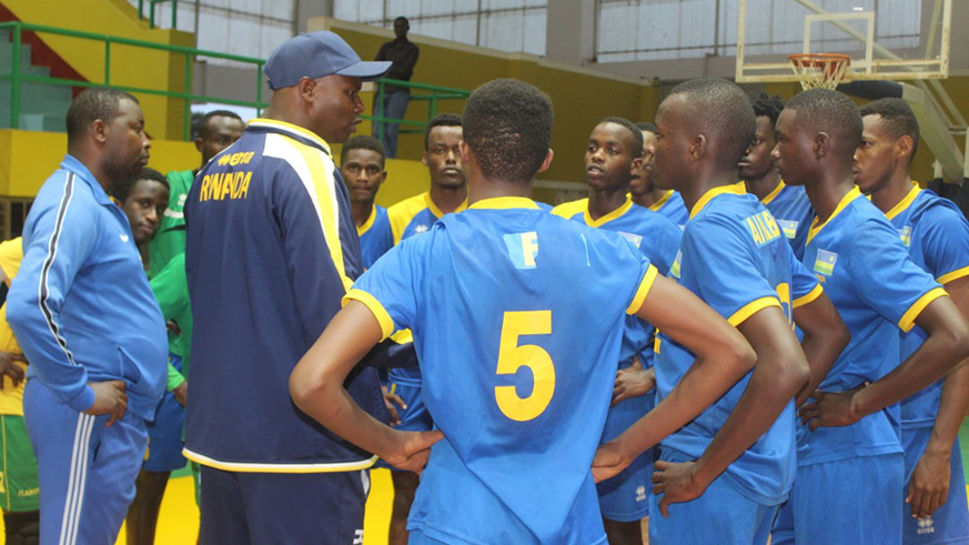 Head coach Paul Bitok gives instructions to his players during a training session at Amahoro Indoor Stadium last week. File photo.
