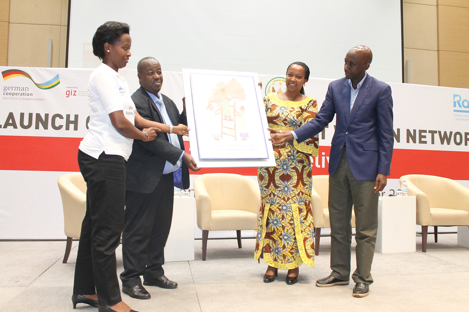 Minister for Gender and Family Promotion, Espu00e9rance Nyirasafari  (2nd R), and Local Government minister, Francis Kaboneka (L) with newly elected head of Rwanda Network of Women in Local Government, Marie-Chantal Rwakazina (L). Courtesy photos 