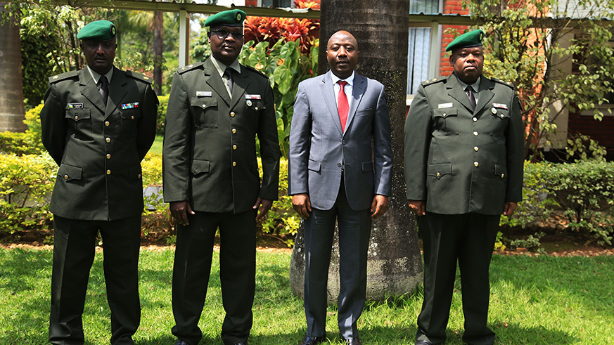 Prime Minister Edouard Ngirente poses with the new Military High Court judges Lt Col Augustin Ngabo (2nd left) and Maj. Charles Sumanyi (left), and new Military Tribunal vice president Lt Col Charles Madudu Asiimwe (right) after they were sworn in at the Prime Ministeru2019s Office in Kigali yesterday.  Sam Ngendahimana.